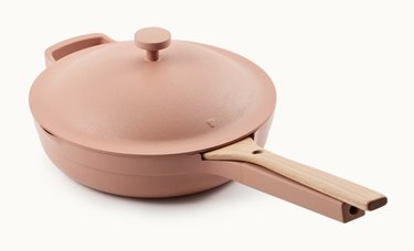 Rose colored ceramic pans with wood spoon.