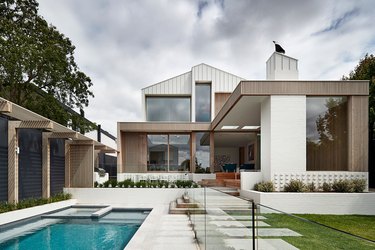 contemporary home exterior with an airy, coastal palette with pool in backyard