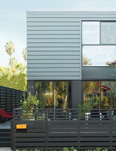 Contemporary home exterior in gray with modern deck
