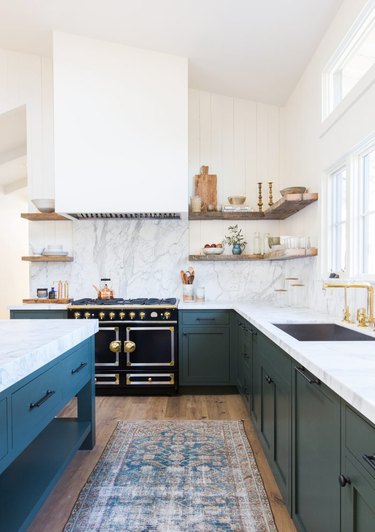 white and green kitchen with retro stove la cornue