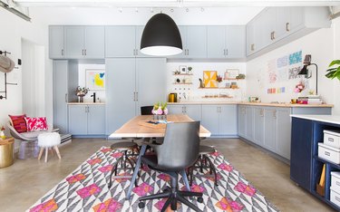 Garage office with colorful area rug and concrete floor