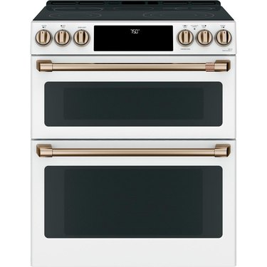 Double oven stove in white with brushed brass hardware