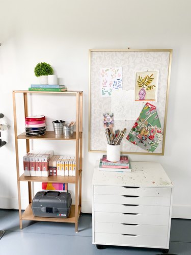 Garage office with white filing cabinet and gold shelf