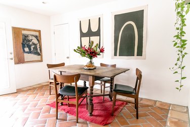 dining room with saltillo tile and pink rug