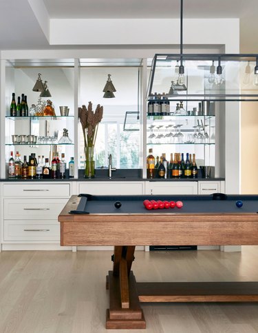 Pool table, built in Contemporary Bar with mirrors, hard wood floors.