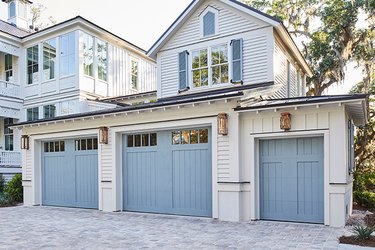 blue craftsman style garage door on white house