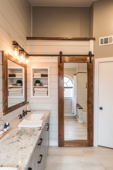 Wood Contemporary Barn Doors with full length mirror, white shiplap walls.