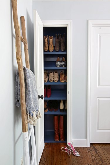 Slim Shoe bedroom closet idea by Hunted Interior with blue tilted shelving