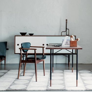 office space with white rug and blue chair