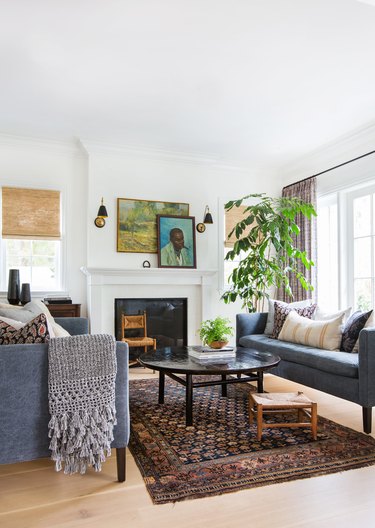 fabric family room window treatments in family room with vintage art and patterned rug