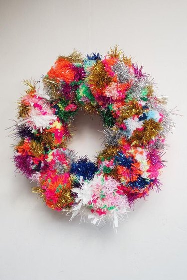 colorful pom pom wreath with tinsel for Christmas decorations list