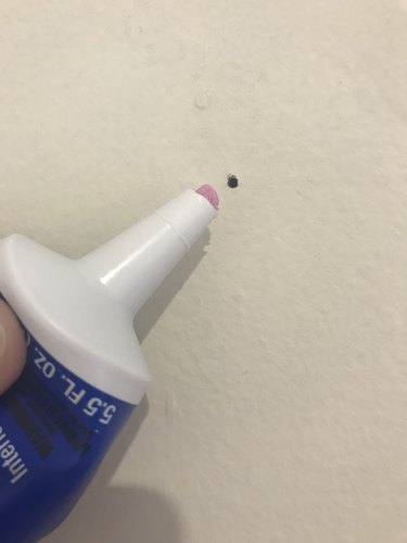 putting spackling on a nail hole