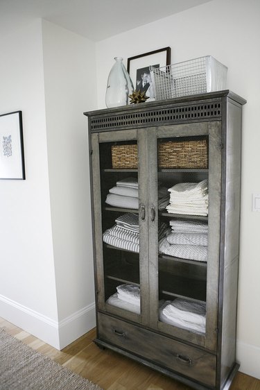 linen closet organization with cabinet filled with linens