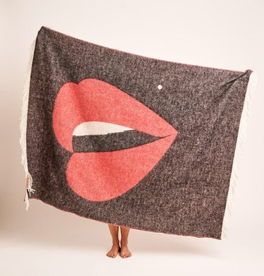 person holding blanket with lip illustration