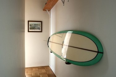 hallway with surfboard on the wall