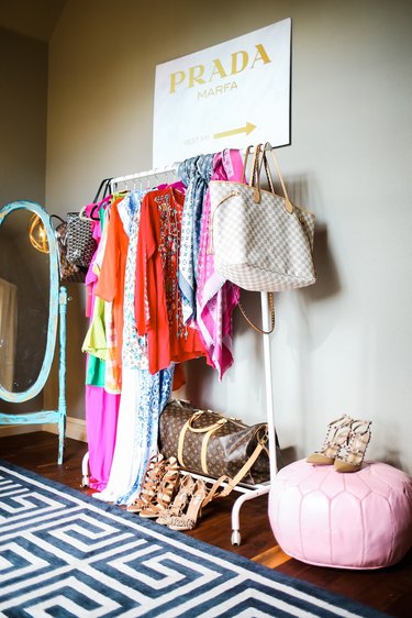 Purses hanging off a clothing rack