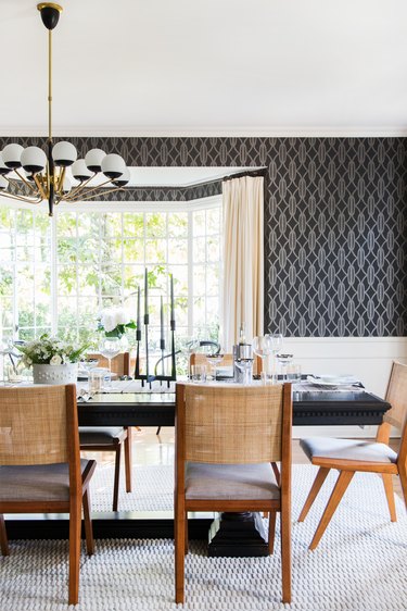 dining room with dark wallpaper and modern pendant