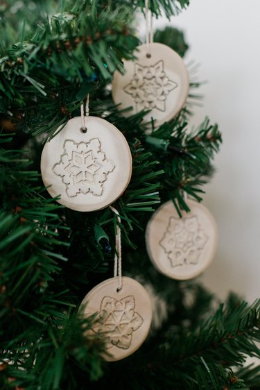 Hang your finished clay ornaments on the tree.