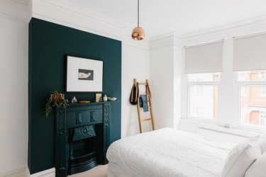 Bedroom with blue wall and fireplace