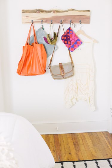 Purses hanging from upcycled wood