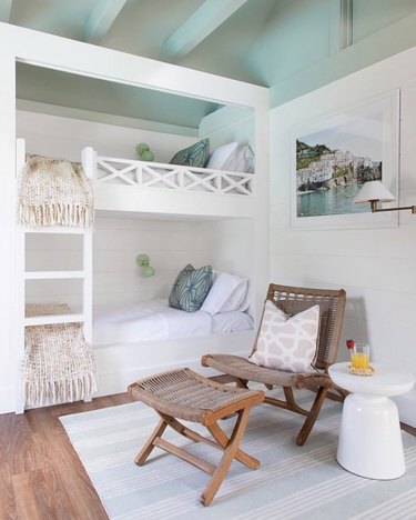 beach chic bedroom with white bunk beds and ceiling beams
