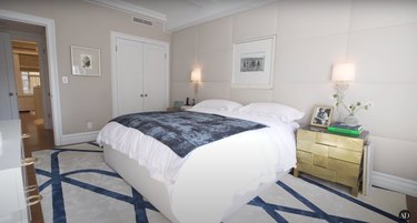 misty copeland bedroom featuring padded walls, gold nightstands, and a white bed