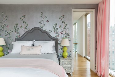 Feminine/romantic bedroom with upholstered headboard and floral wallpaper