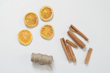 dried orange with cinnamon sticks and string