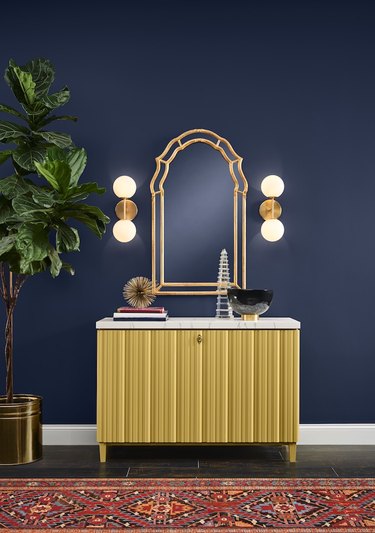 entryway with navy walls and credenza