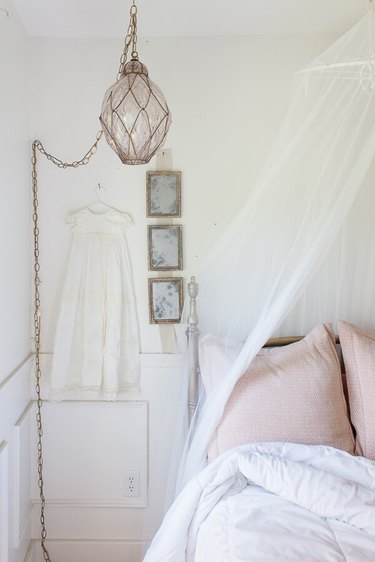 Vintage decor in French country bedroom with bed canopy and pendant light