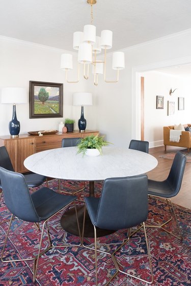 dining room space with blue chairs and chandelier