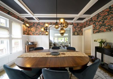 dining room space in a craftsman house with wallpaper above the trim