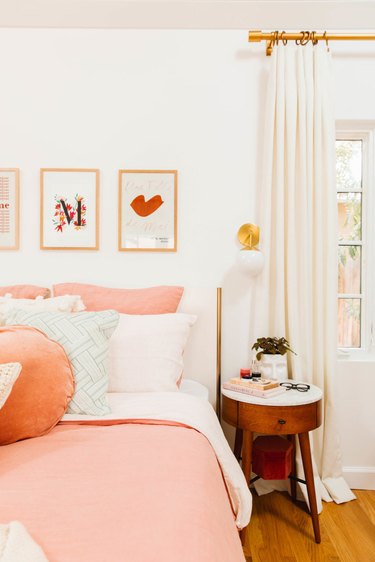 Contemporary bedroom style with pink bedding and floor to ceiling drapery