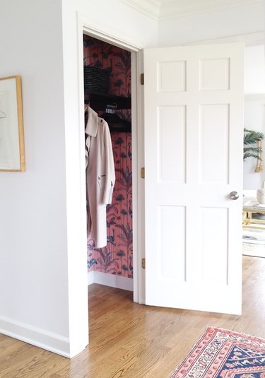 hallway closet storage idea with woven baskets on shelf and matching hangers