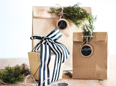 take out bags with labels and greenery for holiday leftovers