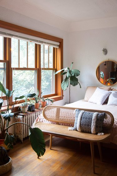 Bed next to large window and natural light