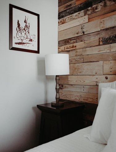 Bedside table with reclaimed wood wall