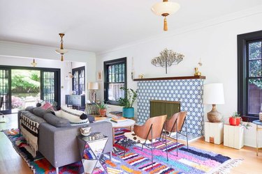 Cali-style living room with blue tile fireplace and colorful rug.