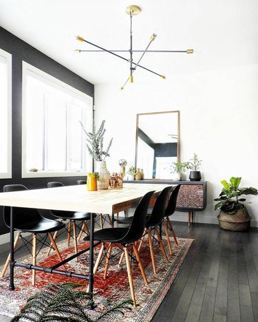 black dining room color idea with wood table and patterned area rug