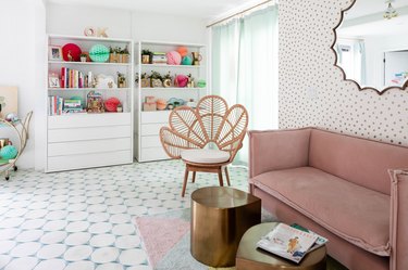 A colorful mid-century living room with sheer curtains on the patio doors