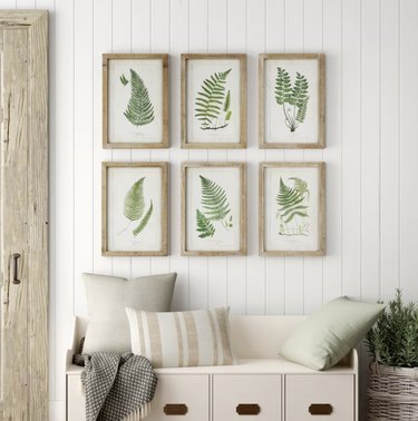 Birch Lane farmhouse decor in hallway with tongue and groove walls with botanical artwork