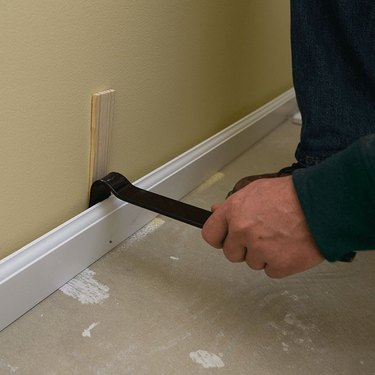 Prying off baseboards.