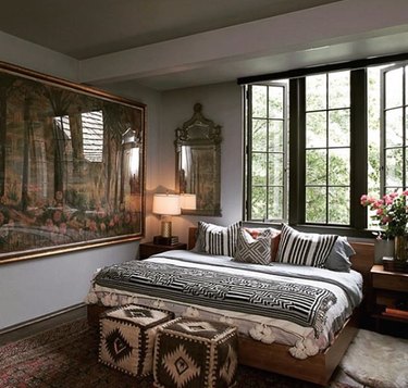 eclectic bedroom full of patterns and large scale artwork