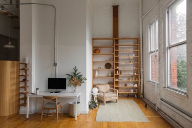 office space with white walls and wooden shelf 