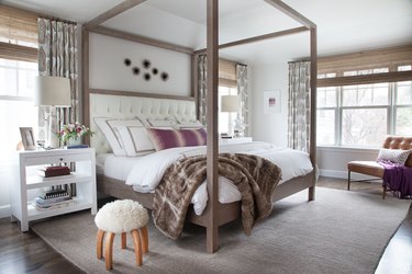 neutral and purple bedroom color idea with canopy bed and floor to ceiling drapery