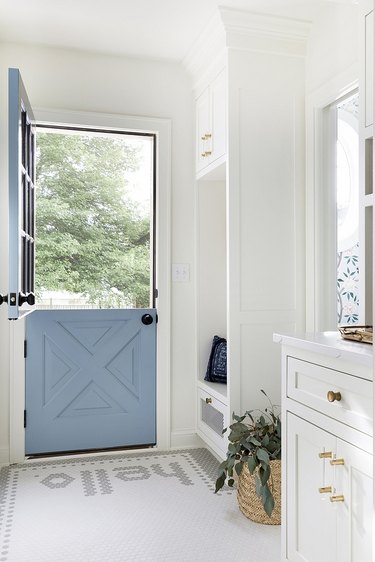 mudroom with the word hello in mosaic tile at door