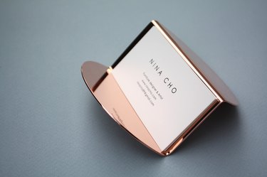 business card in rose gold holder