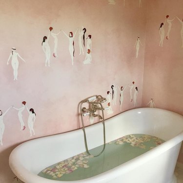 A bathroom with pink wallpaper