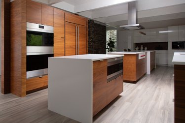 open kitchen with dark wood cabinetry and white countertops