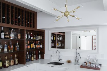 bar set up with bar faucet and sink and modern light fixture above